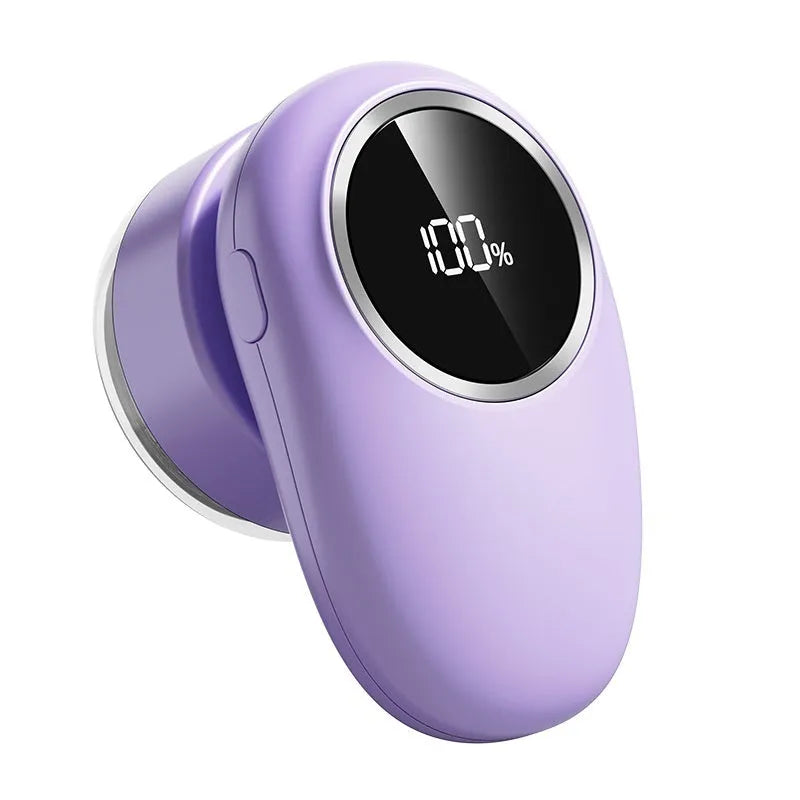 Beige and purple electric fur ball trimmer with digital display and multiple cutter heads on a table