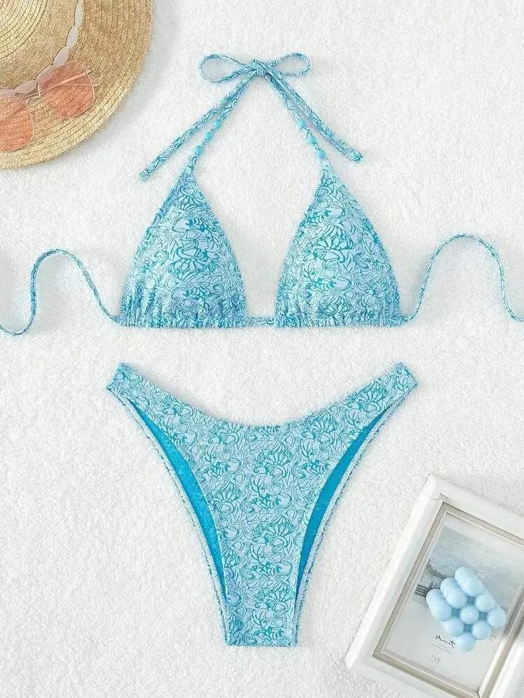 Women's flower pattern halter bikini top and shorts set in emerald green.
