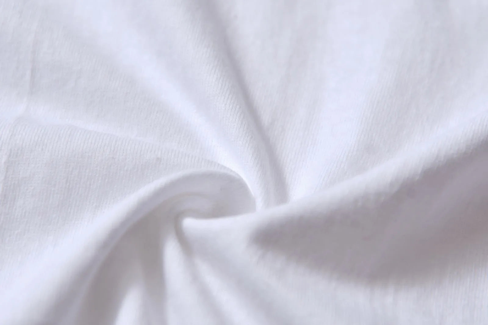 White patterned cotton pullover top with short sleeves on a hanger