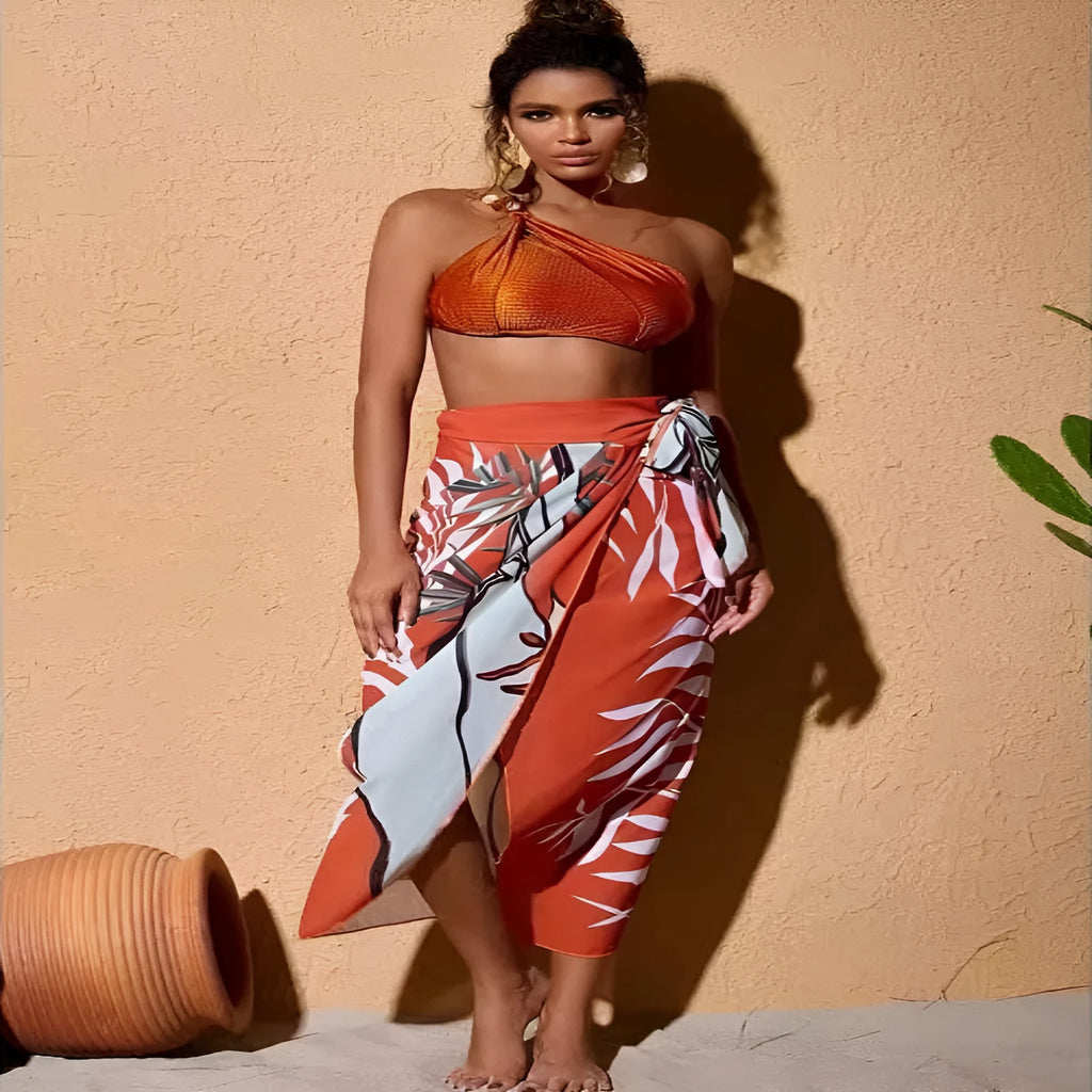 Women's brown high waist bikini with a sheer chiffon dress overlay attached.