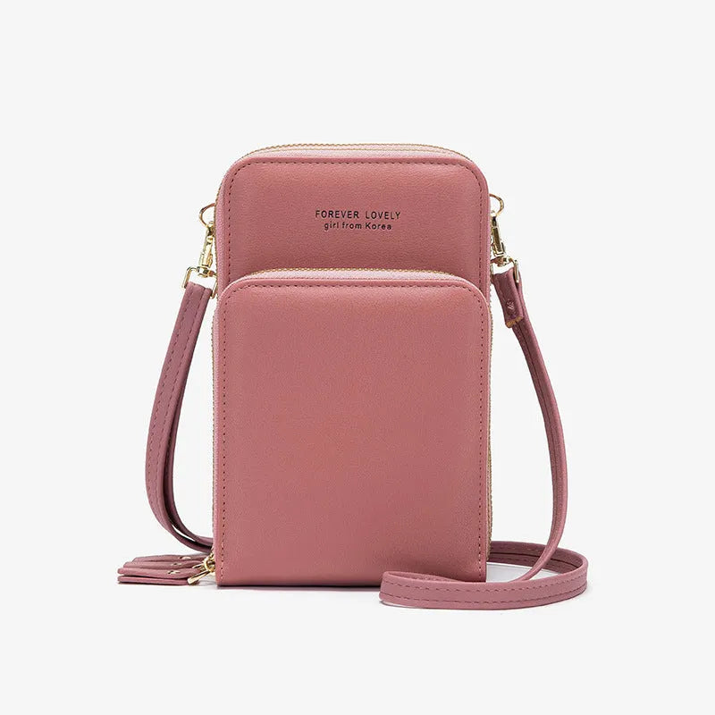 Green crossbody bag with tri-fold pockets and zipper closure on white background