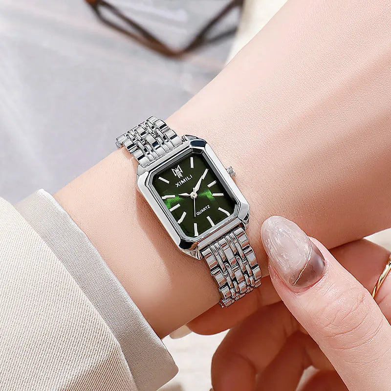 Simple square women's watch with alloy strap, quartz movement, and silver case on a white background