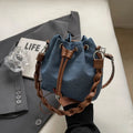 Blue one-shoulder cross body bucket bag with sandwich pocket design and messenger styling