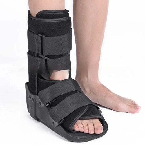 Black Achilles tendon rehabilitation boot with aluminium uprights on a grey background.