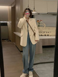 Korean style solid colour polyester commute jacket with long sleeves and pockets on a hanger.