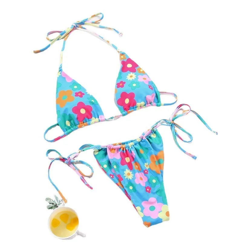 Women's polka dot and floral print split swimsuit bikini set on a mannequin.
