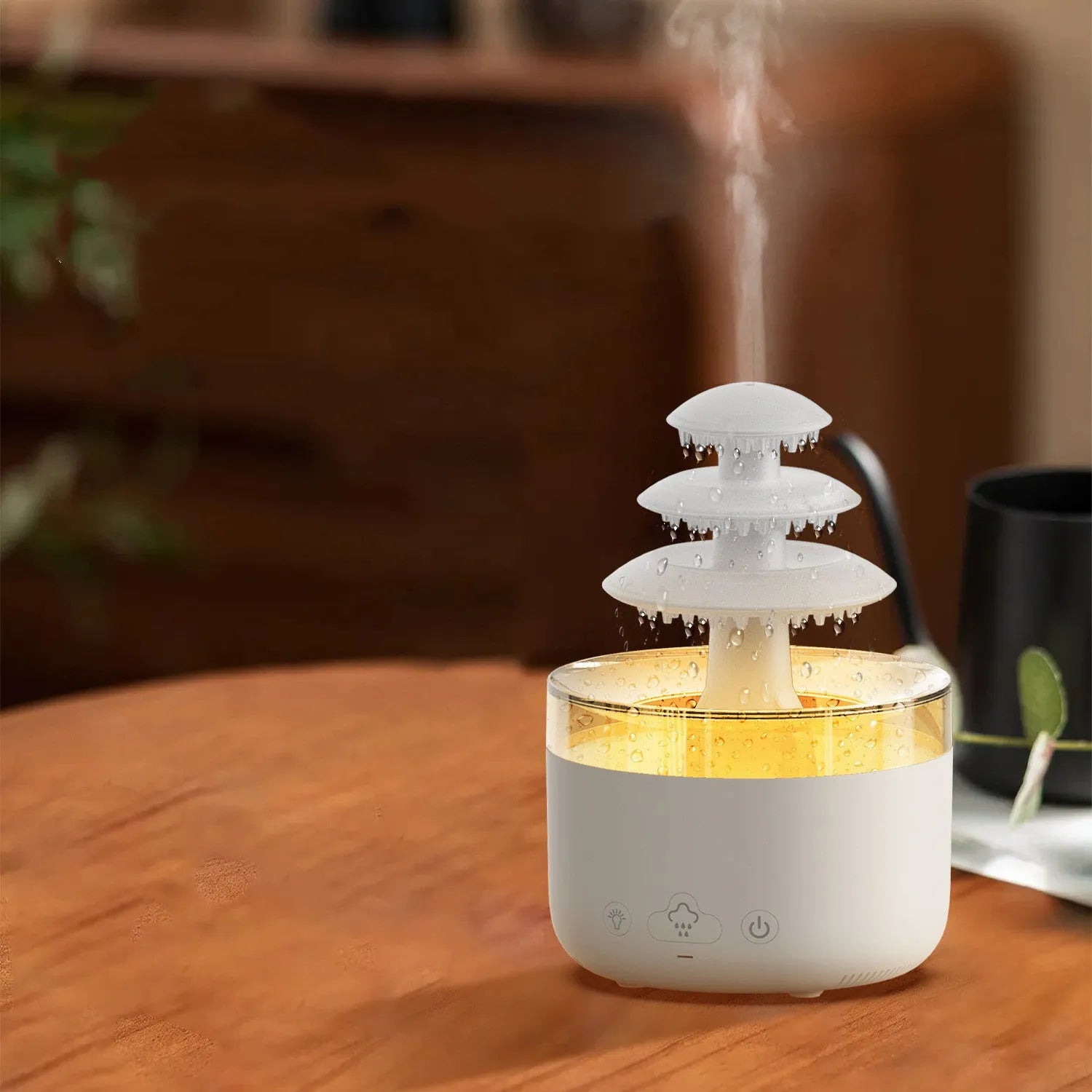 White cloud rain design ultrasonic air humidifier and essential oil diffuser with colourful LED lights on a table.