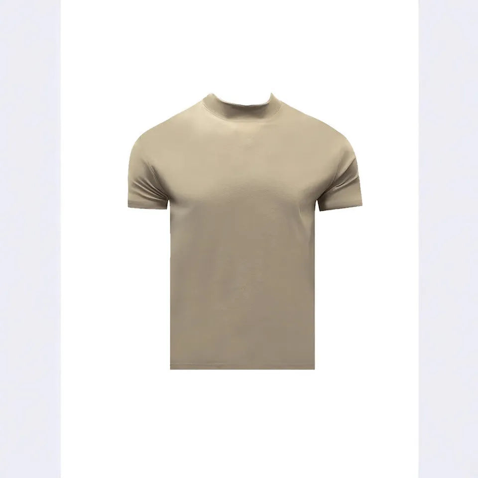 Man wearing a loose-fit grey cotton short-sleeve t-shirt with a half turtleneck cuff shoulder detail.
