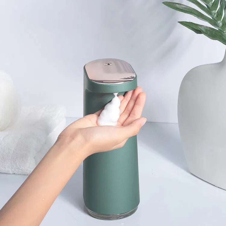 White automatic foam soap dispenser with infrared sensor on a bathroom countertop