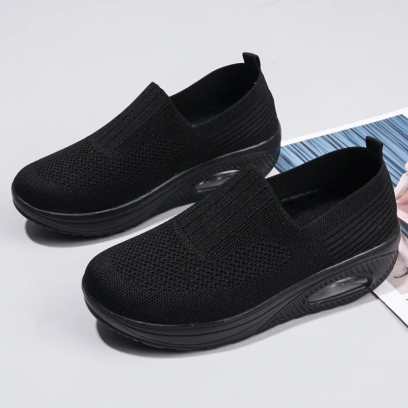 Women's black mesh running shoes with round toe and mid heel on a white background