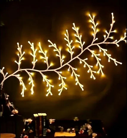Flexible willow vine Christmas garland with birch bark texture and warm white LED lights extended along wall