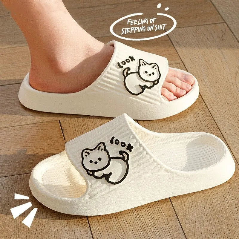 Women's green cat-themed platform slippers with non-slip EVA sole on a wooden floor.