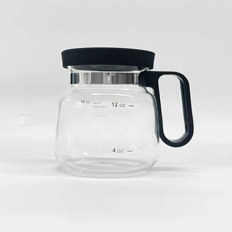 Transparent borosilicate glass coffee maker with a black silicone cover on a kitchen counter.