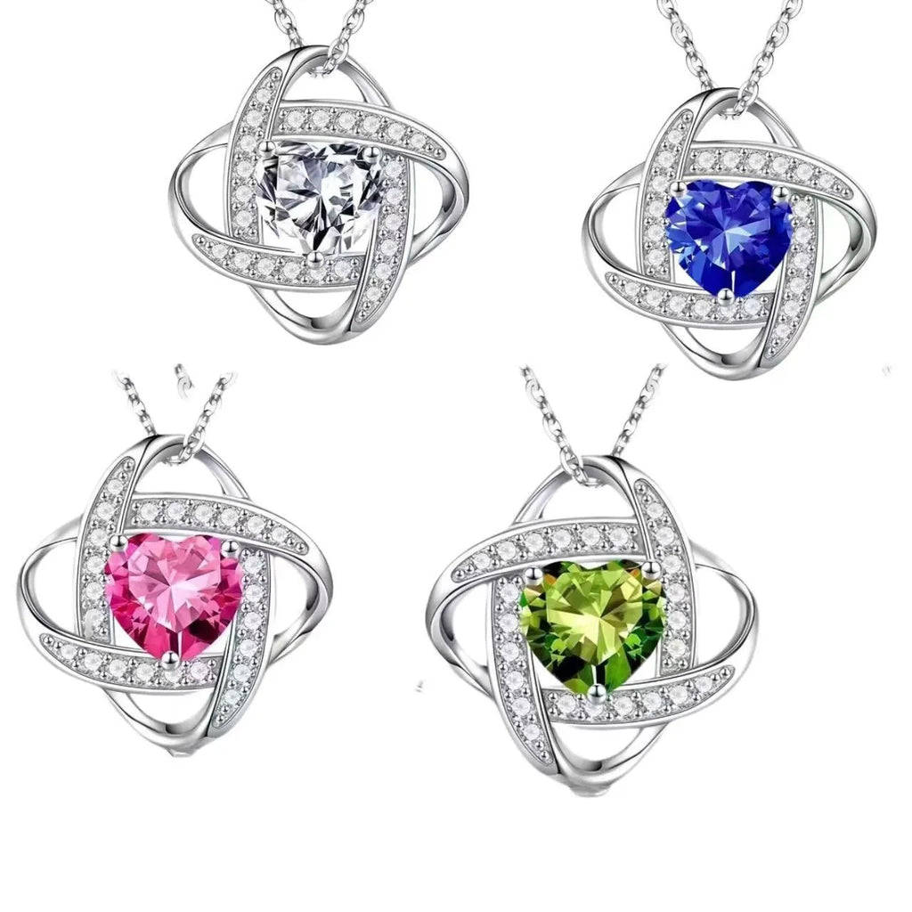 A heart-shaped pendant necklace with a platinum-colour electroplated finish and a coloured crystal centre.