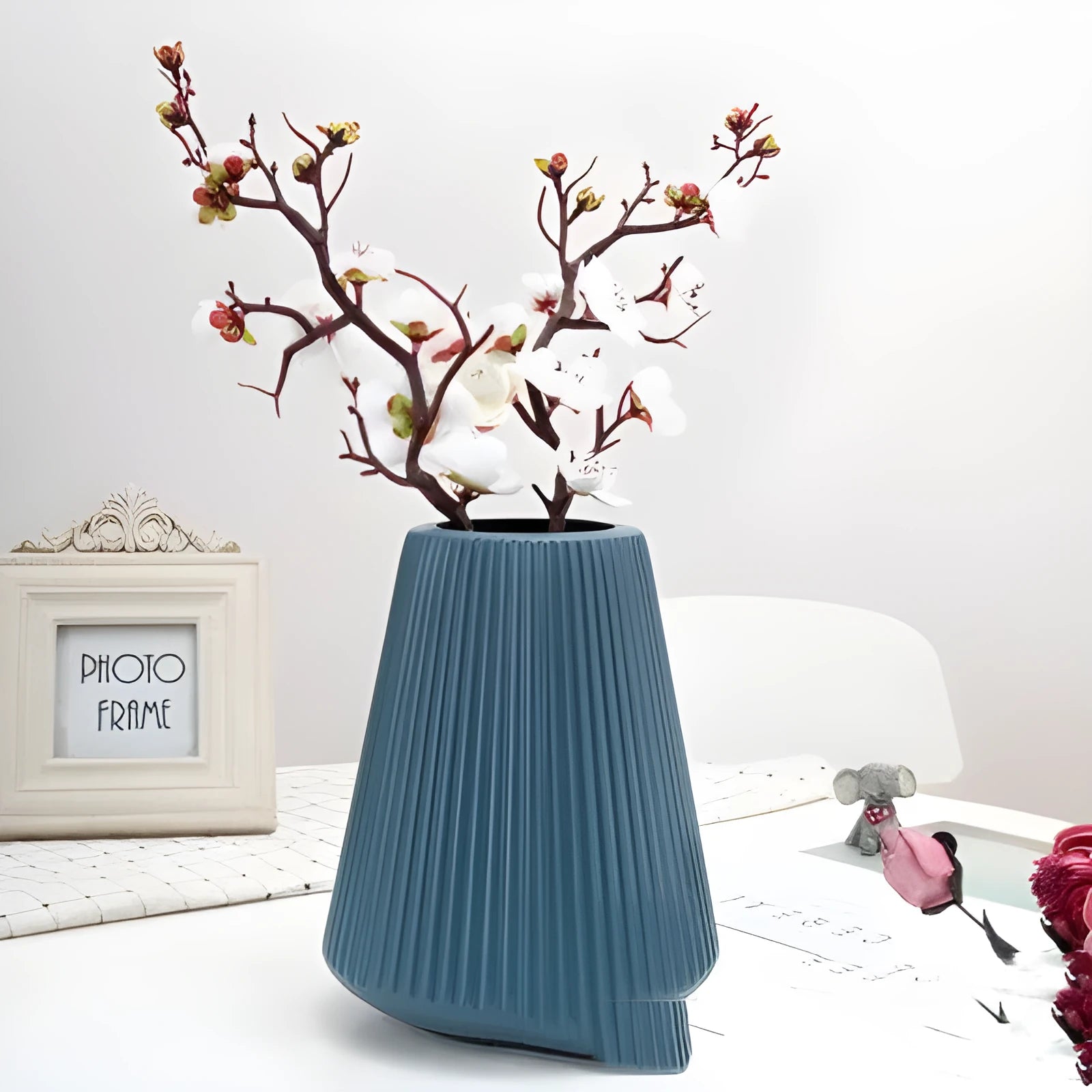 Colourful melamine plastic decorative flower vase, 16 cm by 20 cm, on a desktop.