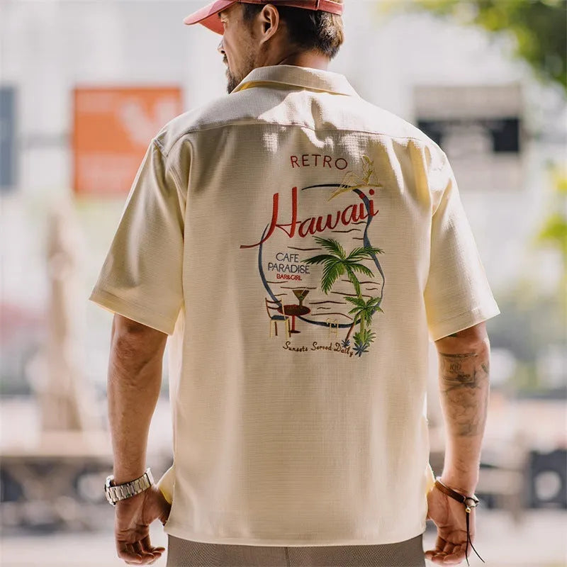 Light apricot men's shirt with bamboo floral pattern and Cuban collar.