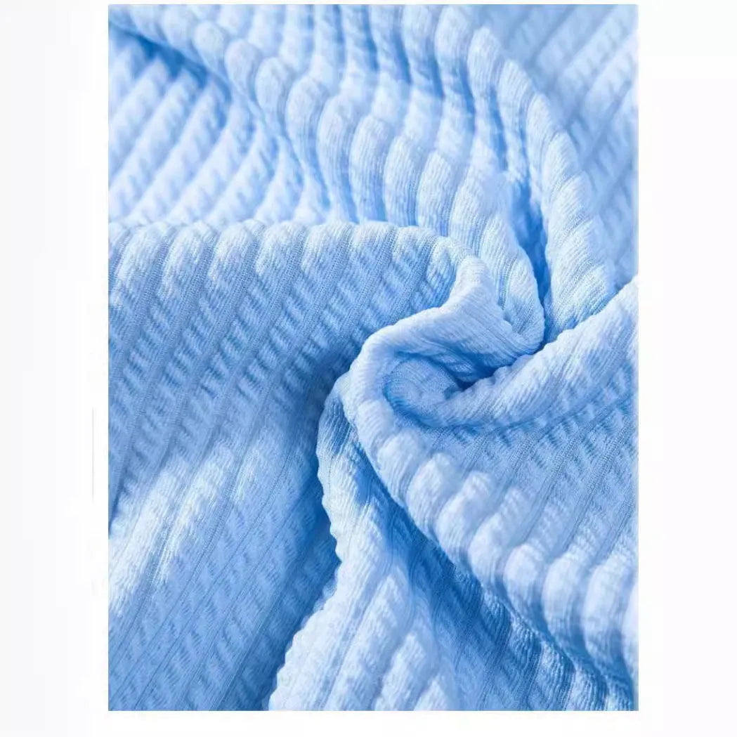 A man's loose-fitting short sleeve casual shirt in a solid colour, made from lightweight polyester fabric.