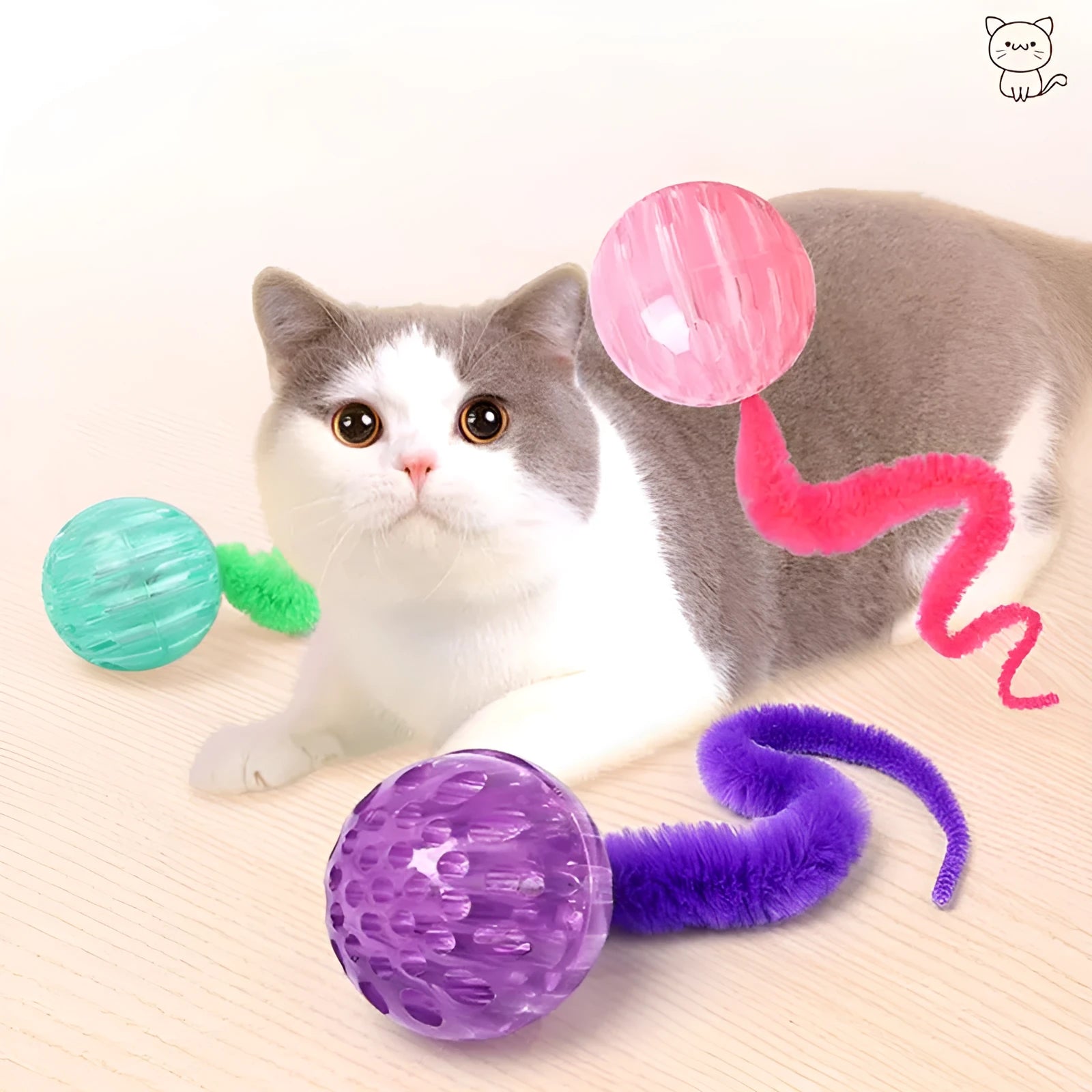 Green bouncy worm-shaped cat toy with a long plush tail on a wooden floor.