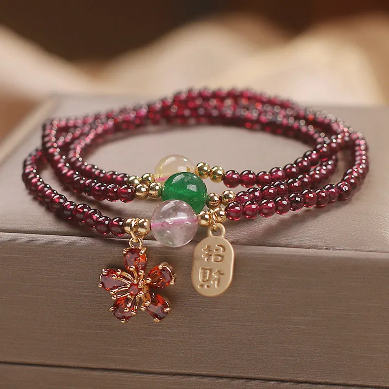 Women's natural crystal bracelet in pomegranate red cherry blossom colour with sequin accents