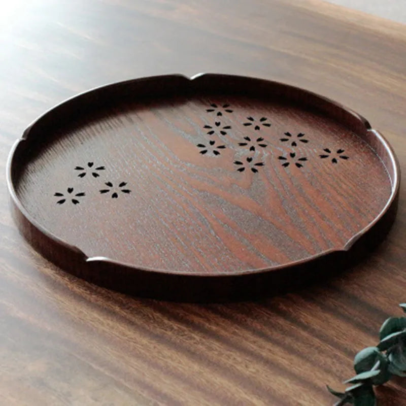 Wooden shallow plate with hollow cherry blossom decoration, 30 cm diameter.