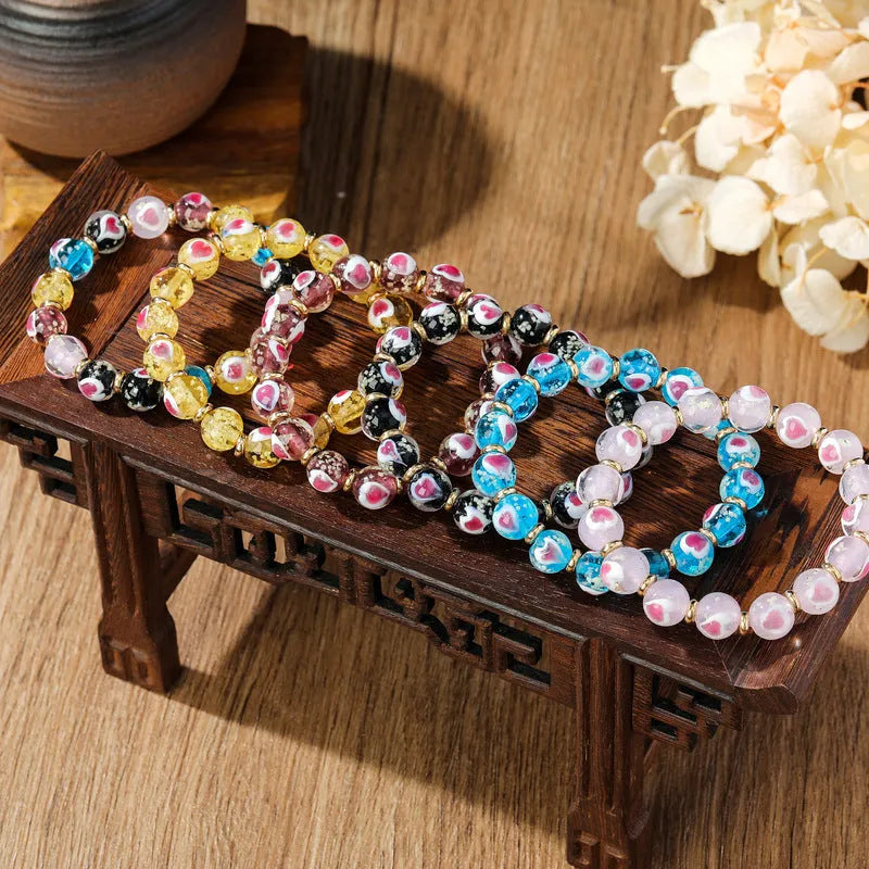 Handmade glass bracelet with swallowing gold beast design and heart shape in various colours