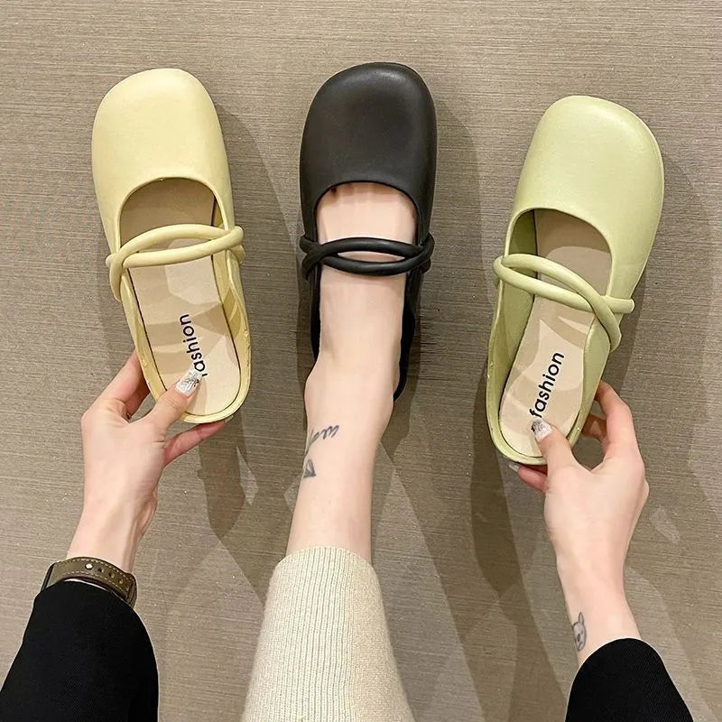 Women's black closed-toe plastic flip flops on a plain background, showing baotou style and strap design.