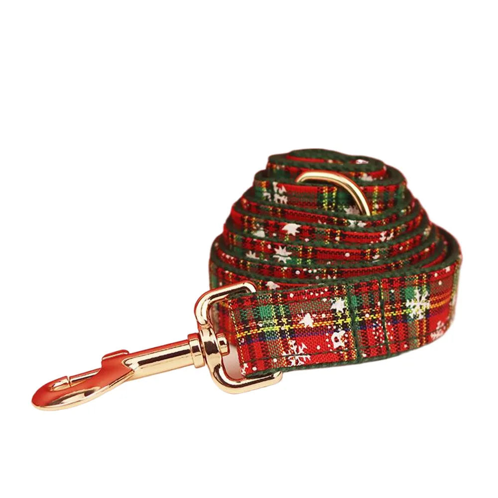 Christmas pet collar four-piece set with green background snowflake design showing dog collar, leash, vest and matching bow