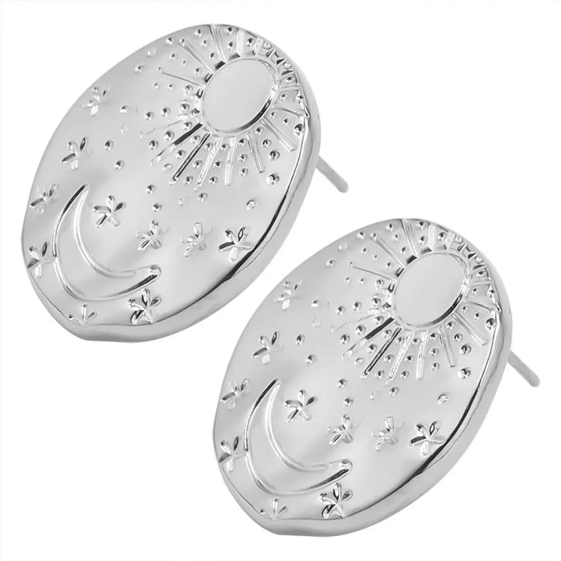 A pair of geometric-shaped stainless steel ear studs with a shell detail, shown in gold and silver colour options.