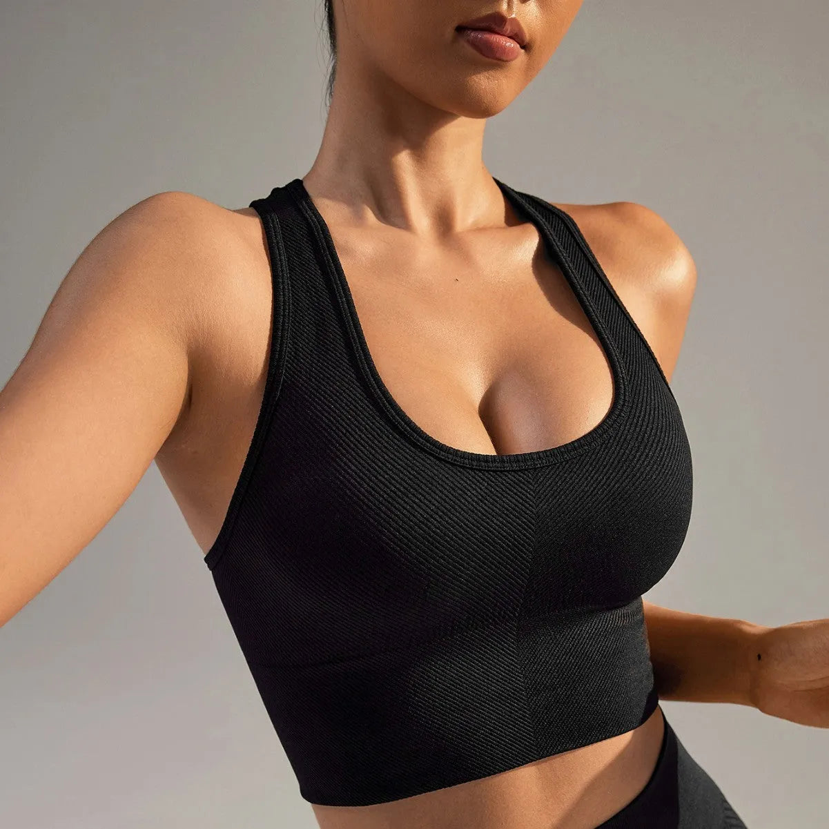 Black women's cross back sports bra with double straps and full cups for running and yoga.