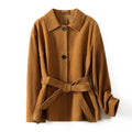 Yellow brown mid-length coat with Peter Pan collar and leather stitching on front.