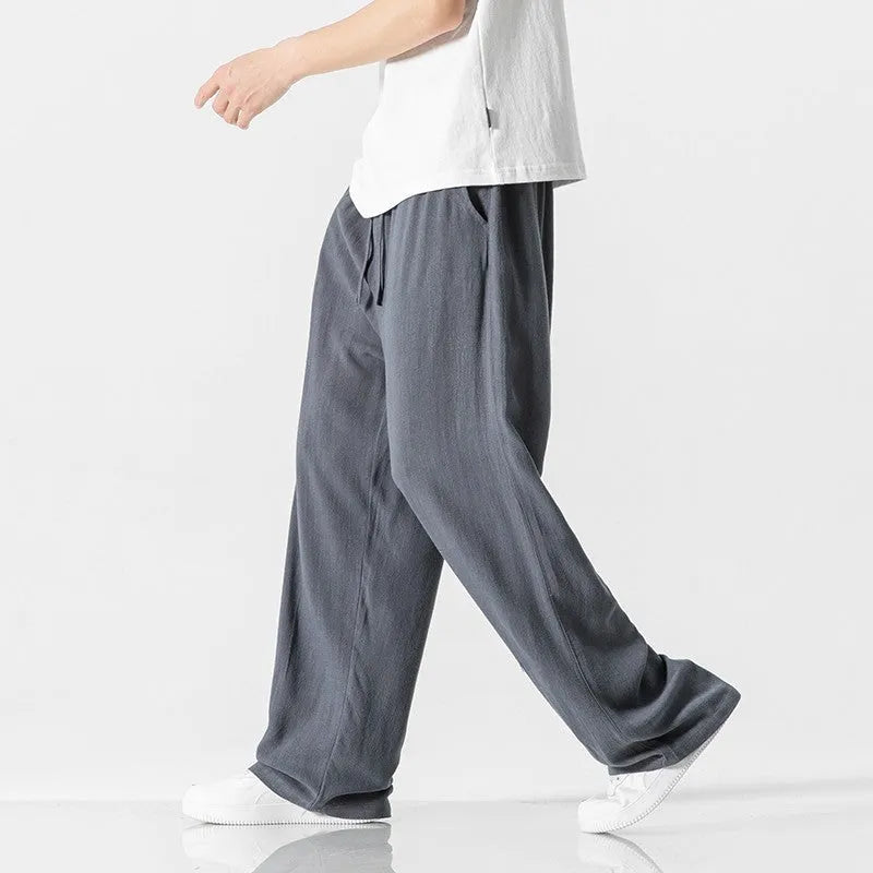 Men's beige linen-blend cropped trousers with a drawstring waist on a plain background.