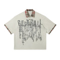 Men's loose blue cotton short-sleeve top with asymmetric cut and graffiti print on lapel.