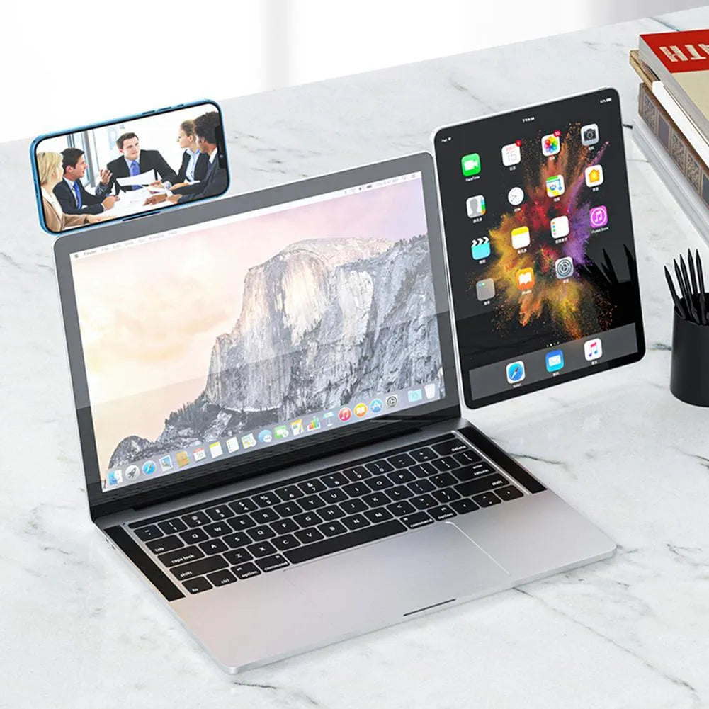 Black aluminium laptop phone holder clipped to side of monitor with smartphone attached.