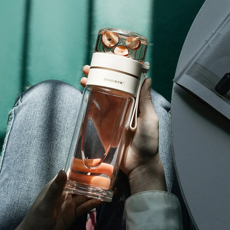Glass water bottle with tea infuser filter showing double wall construction and portable rope