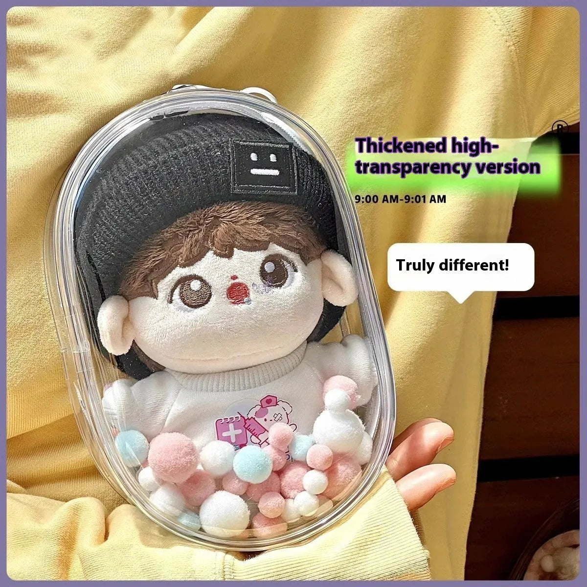 Clear PVC cube-shaped storage bag with colourful ball keychain for cotton dolls and collectibles.