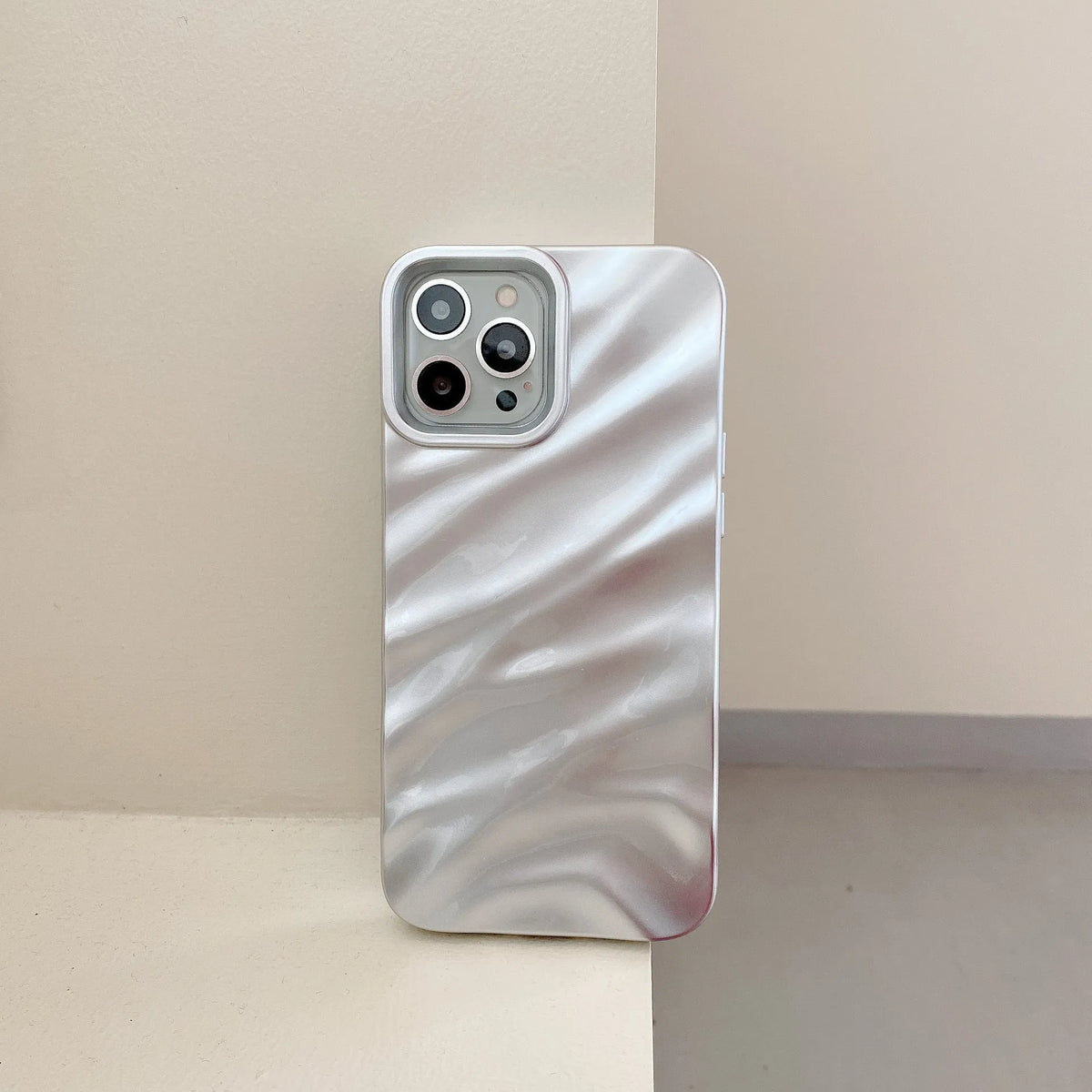 Soft solid colour wave pleated phone case for Apple iPhone 17 on a neutral background