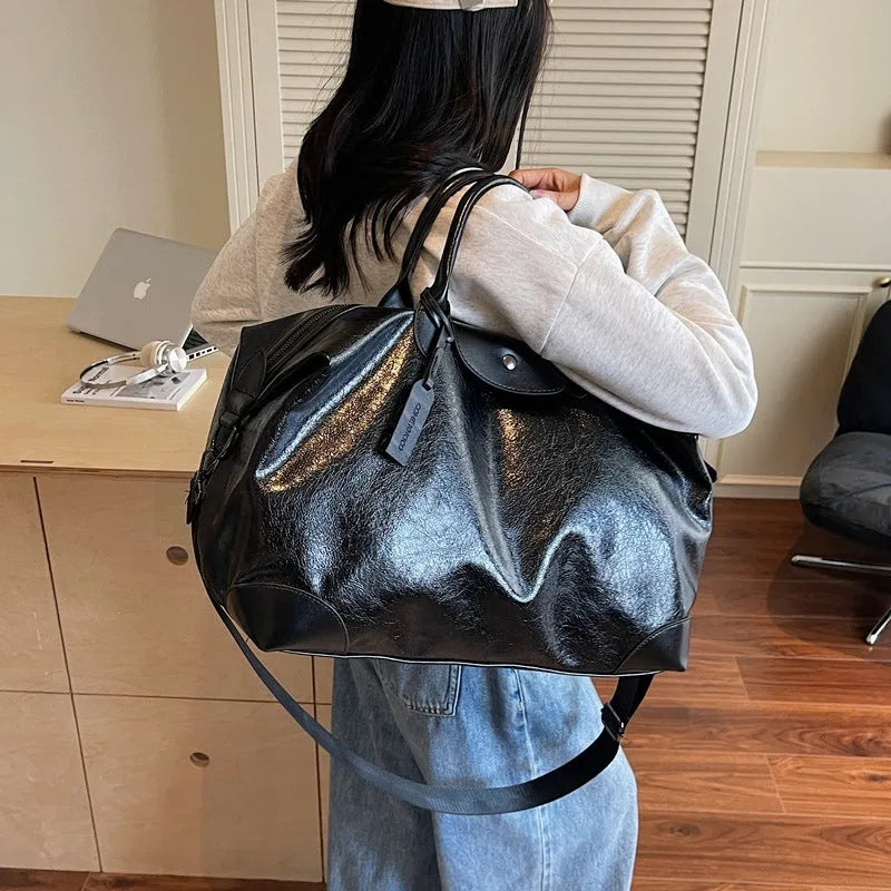 Black women's hand-carry travel bag with 36-55 litre capacity for short trips