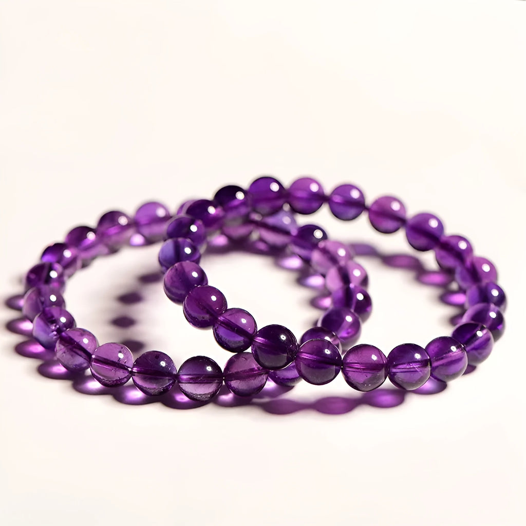 Adjustable bracelet with scattered, polished natural amethyst beads from Uruguay on a wrist.