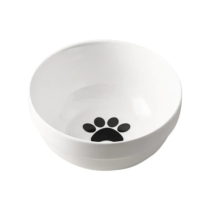 White ceramic cat bowl with cat footprint design on a black iron stand with cat ears.