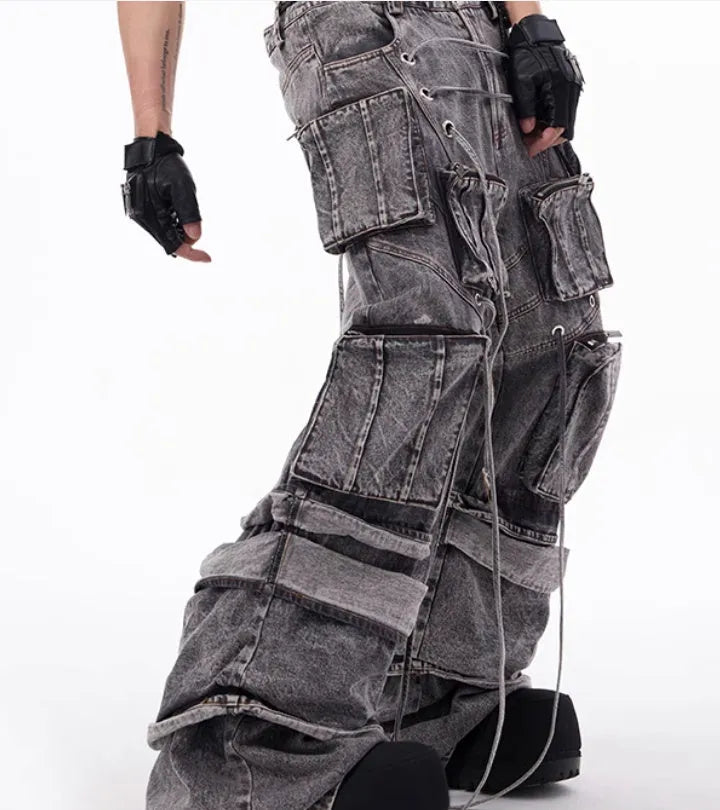 Grey distressed denim mop pants overalls with rope stitching detail on a hanger