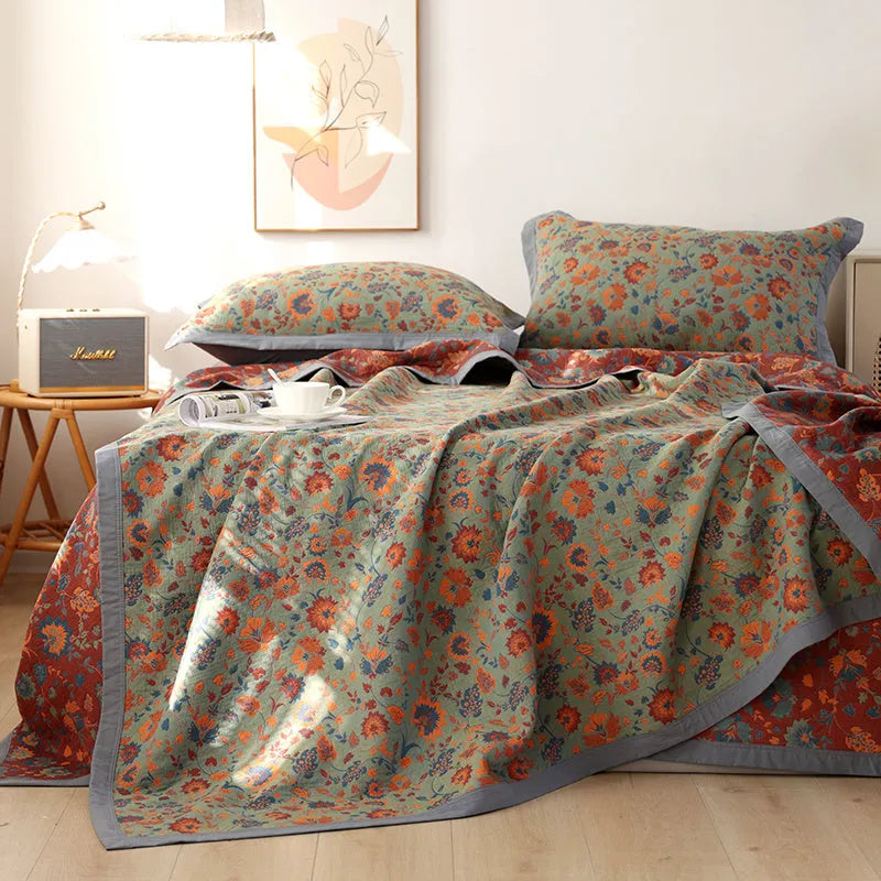 Three-piece cotton gauze bedding set with floral pattern showing blanket and two pillowcases