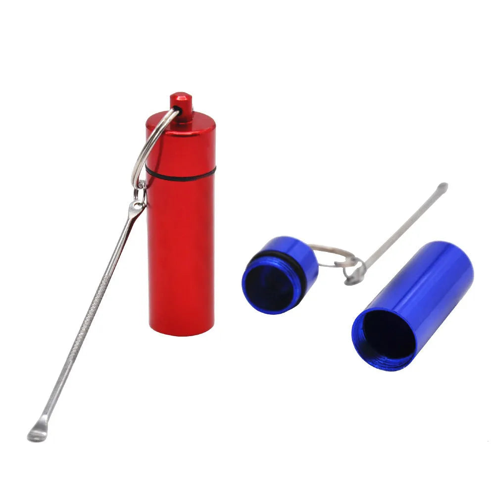 Blue aluminium portable pill storage bottle with an integrated spoon and a silver keychain ring attached.