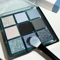 MUGELEEN nine-colour eye shadow palette showing matte and shimmer finishes in low saturation tones