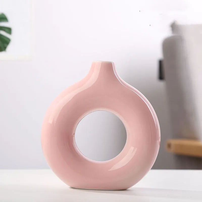 Frosted unglazed porcelain biscuit vase in a simple modern style on a table.