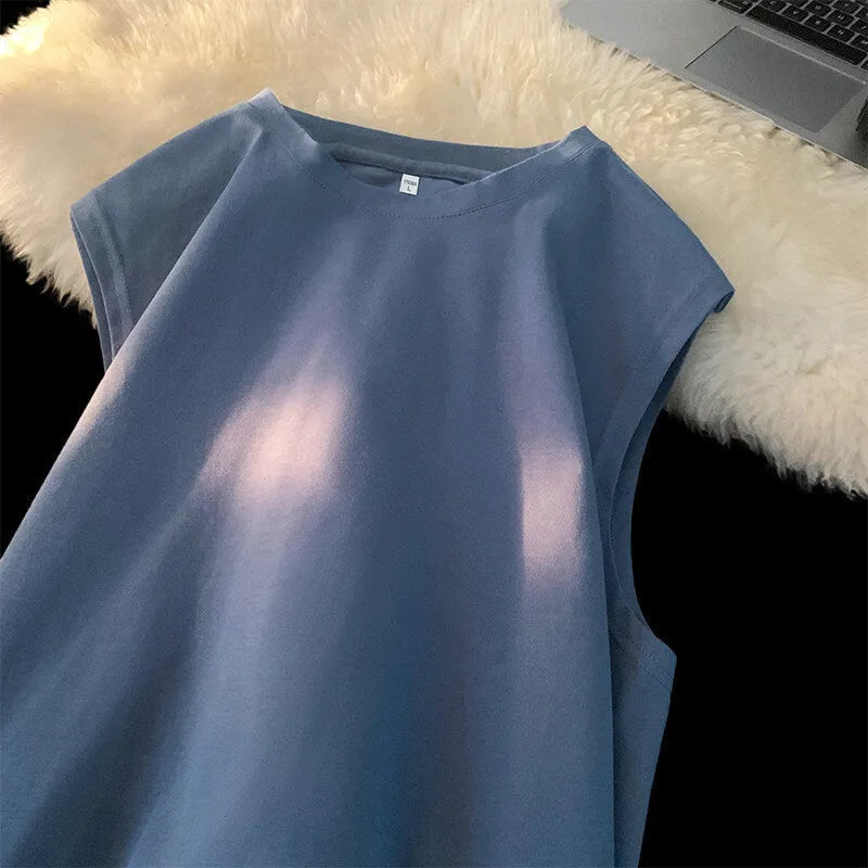 Men's loose sleeveless cotton tank top in a solid colour on a hanger