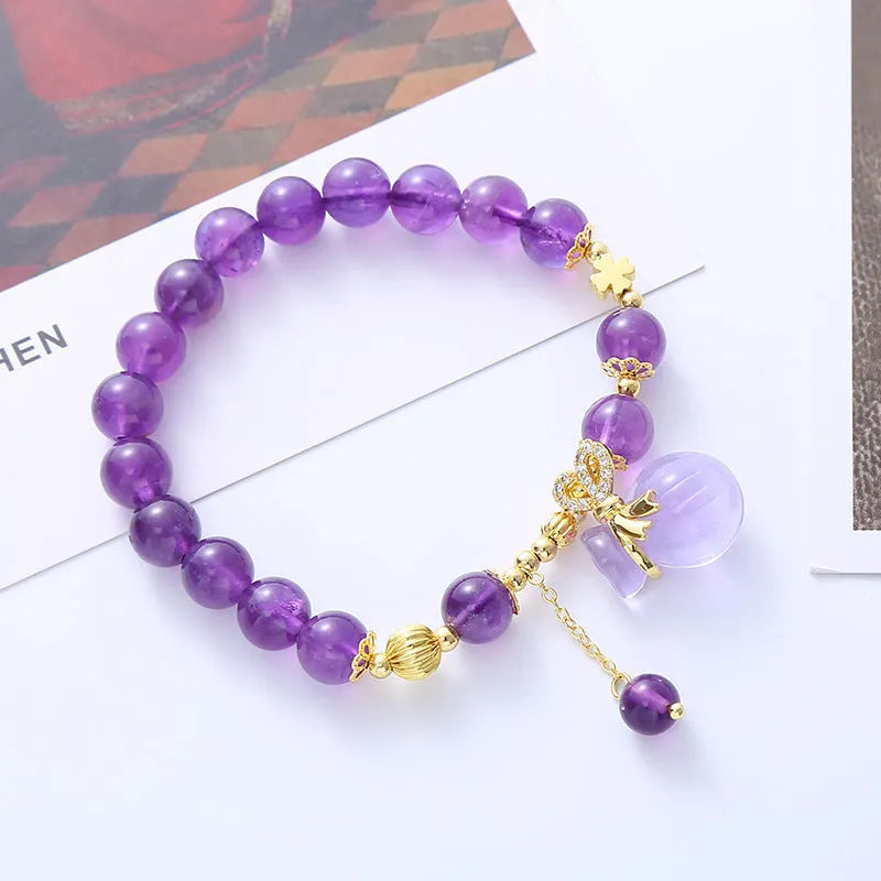 Purple amethyst crystal bracelet with geometric beads showing money bag charm and peace buckle pendant options