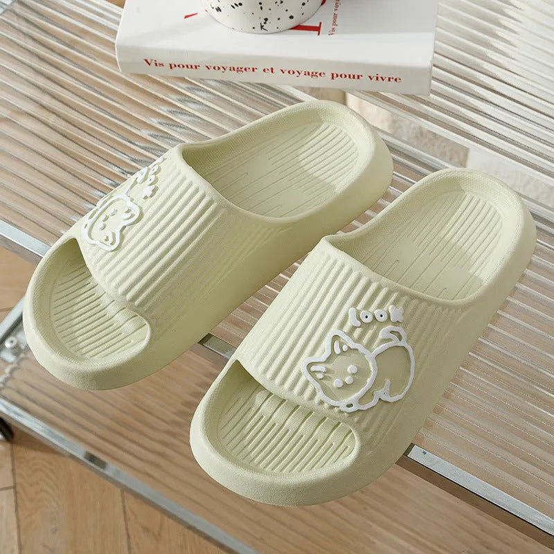 Women's green cat-themed platform slippers with non-slip EVA sole on a wooden floor.