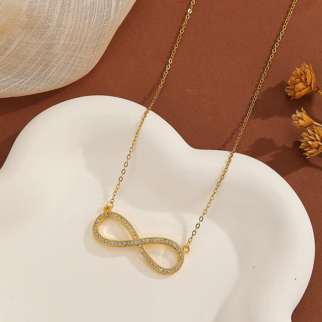 Gold plated copper infinity love pendant necklace with diamond accents and fine chain.