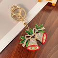 Diamond studded metal Christmas bell keychain in European style on a white background