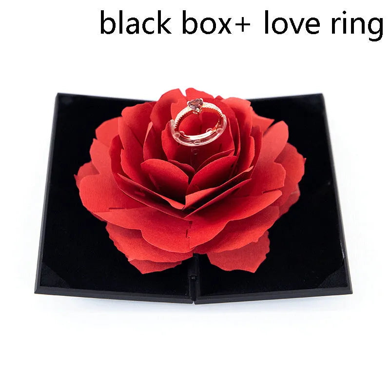 Red heart-shaped plastic ring box with a rose design and rotating 3D love text in the centre.